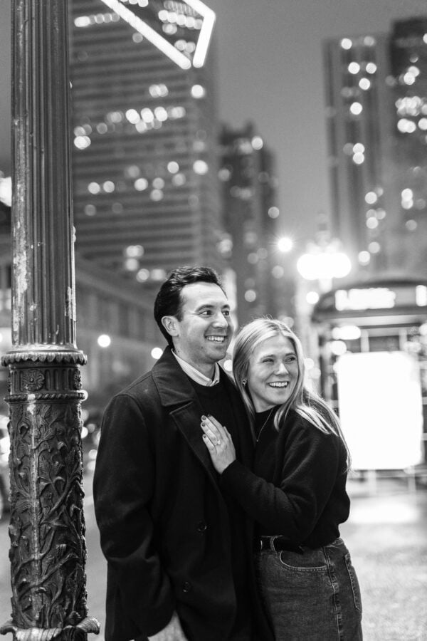 man and his fiance pose for a photo on michigan avenue chicago