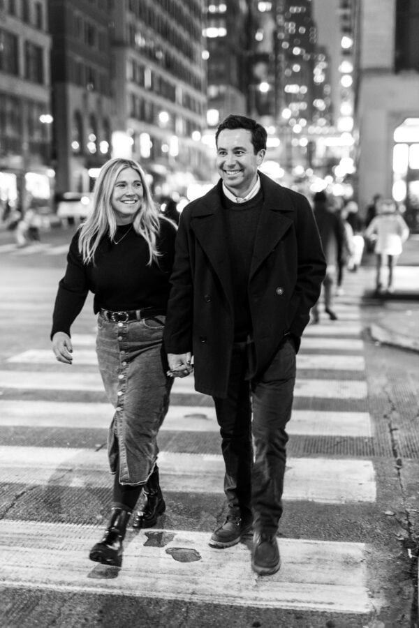 engaged couple walk on michigan avenue at night