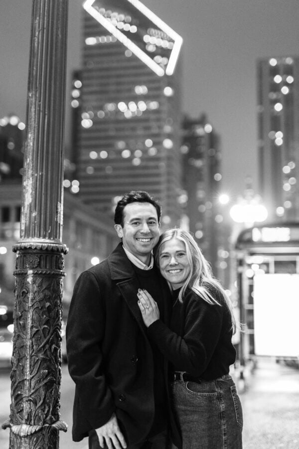 man and his fiance pose for a photo on michigan avenue chicago