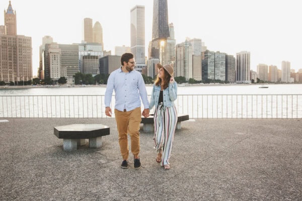 engaged couple poses for a photo at milton lee olive park chicago