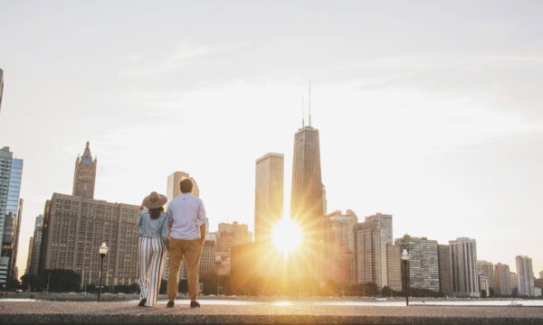 engaged couple poses for a photo at milton lee olive park chicago