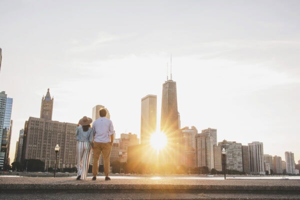 engaged couple poses for a photo at milton lee olive park chicago