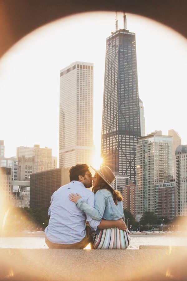 engaged couple poses for a photo at milton lee olive park chicago