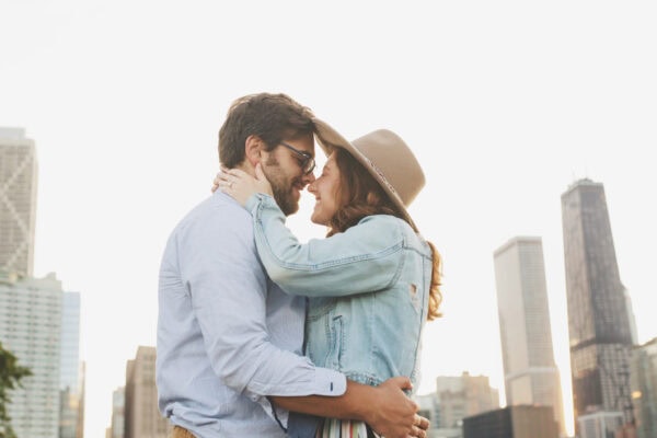 engaged couple poses for a photo at milton lee olive park chicago