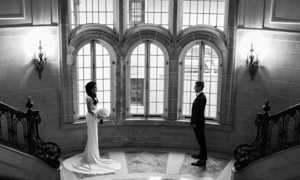 a bride and groom standing on the marble stairs of the armour house in lake forest Illinois