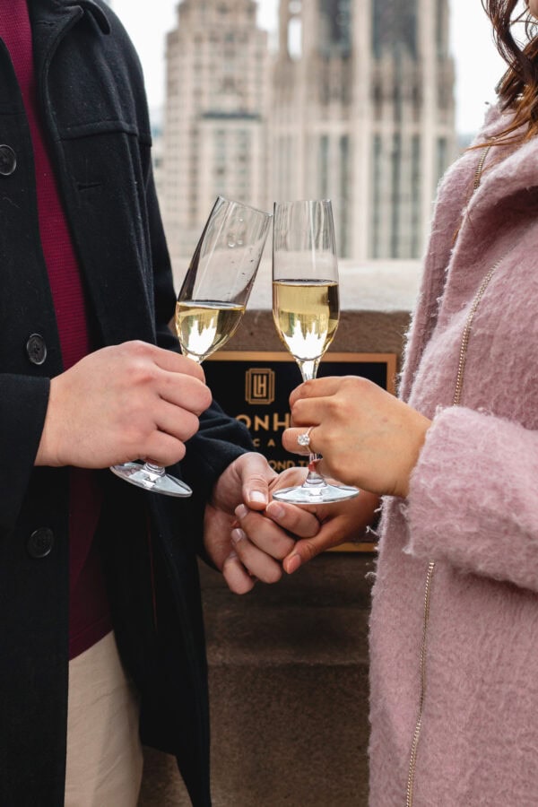 engaged coupled toasts with champagne glasses